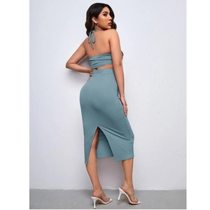 Detail of ribbed knit maternity set with halter neck top and side slit midi skirt