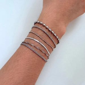 Minimalist six-piece silver-plated stainless steel bracelet set for women shown on wrist