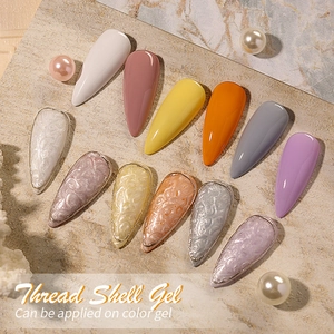 Professional Thread Shell Gel nail polish palette with pearl accents on marble