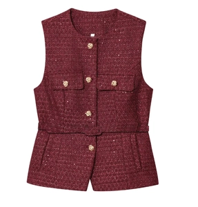 Close-up of wine red tweed vest featuring golden embossed buttons and sequin texture details
