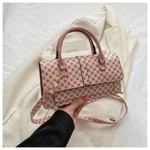 Pink lychee texture handbag featuring circular monogram pattern and golden hardware