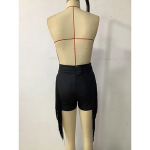 Detail of black slim-fit shorts featuring side tassels and a high-waisted back design