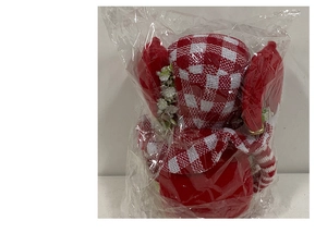 Detailed view of long-legged Christmas gnome toy in a protective packaging wrap
