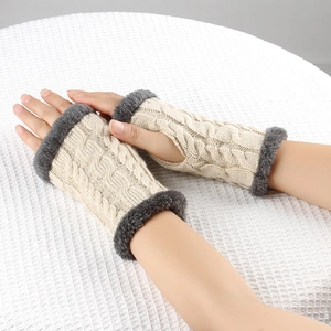 Close-up of beige cable knit fingerless gloves with soft faux fur trim for winter warmth