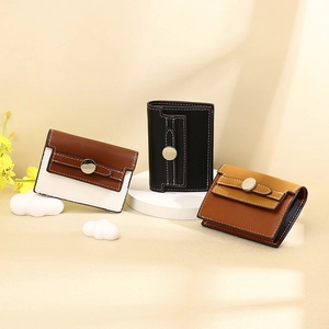 Three leather card wallets in black and tan with stitching and round metal buckles
