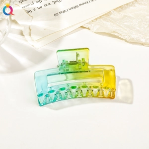 Close-up of a gradient yellow and green square hair claw clip with a durable metal spring
