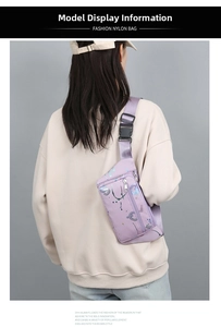 Detail view of purple nylon waist bag with adjustable strap and plastic buckle closure