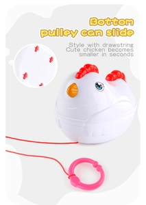 Detail view of the bottom pulley and red drawstring on this cute chicken toy for toddlers