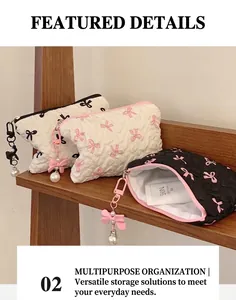 Quilted bow makeup bags with heart patterns and pearl charms on a wooden display