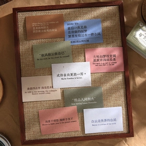 Artistic quote stickers book with assorted colors displayed on a wooden vintage stand