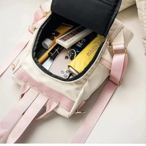Spacious beige Oxford backpack for women with pink trim showing large inner storage