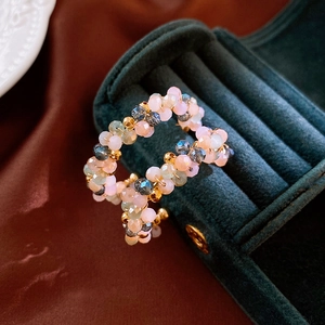 Elegant beaded hoop earrings with colorful crystal stones on a velvet jewelry box display