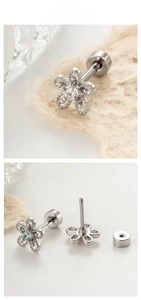 Detailed view of titanium daisy ear studs with zircon inlays and secure screw backings