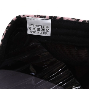 Macro detail of leopard print baseball cap interior showing 100% polyester care label