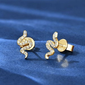 Macro shot of S925 sterling silver stamp on golden snake stud earrings with moissanite