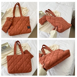 Detail of reddish-brown quilted tote bag with matching coin purse and fashion patch