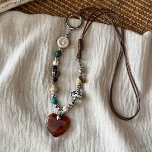 Retro beaded heart pendant necklace with vintage stones and shell charms on linen back
