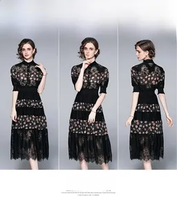 Detail view of the floral print patchwork and delicate lace trim on a black dress