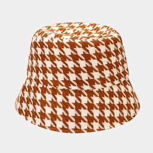 Close-up of brown houndstooth pattern on thick tweed wool bucket hat fabric