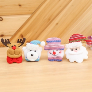 Christmas glowing slap bracelets with Santa, reindeer and snowman on a wood background