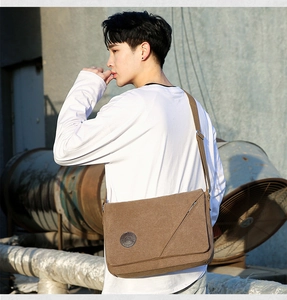 Brown canvas messenger bag for men showing adjustable strap and casual flap design