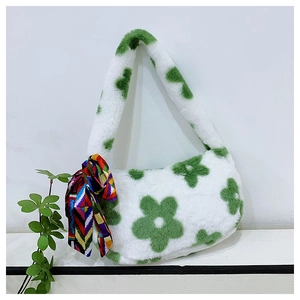Close-up of white plush handbag featuring green flower patterns and colorful silk scarf
