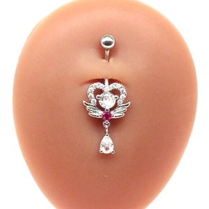 Close-up of winged heart belly button ring with red and clear zirconia stones on model