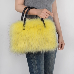 Detailed macro of vibrant yellow faux fur texture on a tote bag with black leather handles