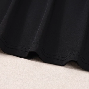 Detailed close-up of double-needle stitching on the black backless maxi dress hemline
