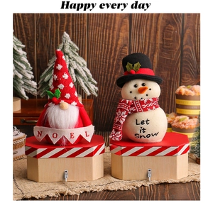 Detail of Santa gnome and snowman figures on wooden hexagonal storage boxes with hooks
