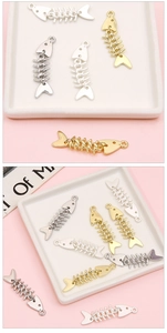 Detailed view of articulated gold and silver fish bone pendants for DIY jewelry