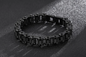 Close-up of black stainless steel motorcycle chain bracelet with metallic texture