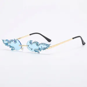 Rimless flame-shaped sunglasses with light blue lenses and sparkling crystal accents
