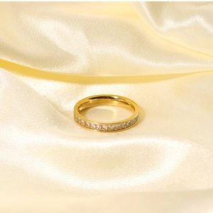 Macro shot of gold-plated eternity ring with rectangular baguette-cut cubic zirconia