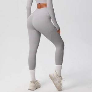 Detail view of high waist yoga leggings with functional side pockets and V-shape seam