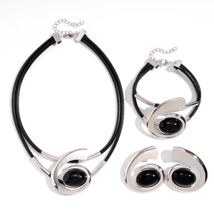 Modern silver geometric jewelry set with spiral metal accents and oval black gemstones