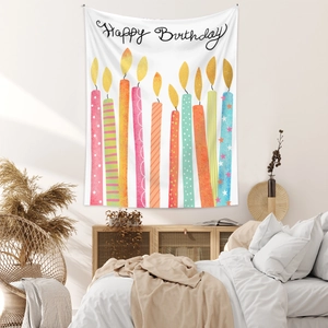 Detail of bohemian Happy Birthday tapestry with hand-drawn candles hanging in a bedroom