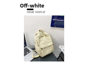 Detail of off-white canvas backpack with top handle and adjustable straps in a lifestyle setting