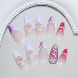 Pink and purple gradient press-on nails with 3D floral accents and elegant pearls