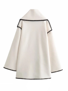 Rear view of white wool coat featuring distinctive black wavy piping detail and clean lines