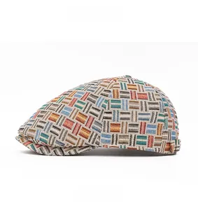 Detail of colorful woven jacquard beret hat featuring metallic side buckle and texture