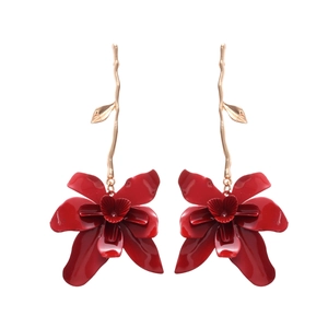 Elegant vintage red flower drop earrings with golden leaf accents on white background