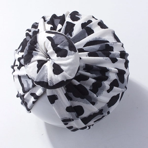 Detail of baby leopard print knotted headwrap showing soft pleated texture and top knot
