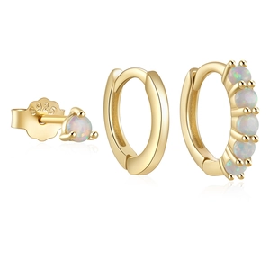 Detailed close-up of S925 sterling silver stamp on golden huggie earrings with opal stones