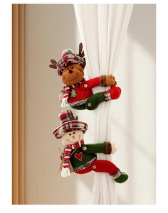Detail of plush snowman and reindeer curtain tiebacks in festive plaid hats and red scarves