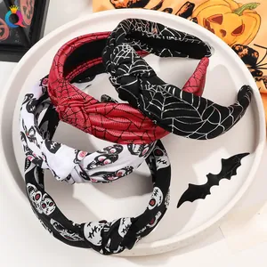 Close-up of four Halloween knotted headbands featuring spider webs and skull patterns