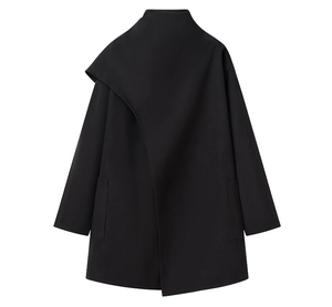 Detail of black mid-length coat featuring asymmetric collar and functional side pockets