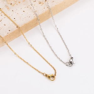 Gold and silver heart zircon necklaces with O-chain and lobster clasp on stone