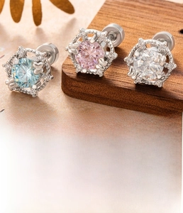 Macro view of crystal zircon screw-back ear studs in sky blue, pink and white with steel base