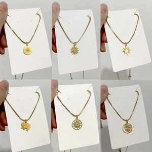 Minimalist 18K gold titanium steel necklace set with diverse charms and snake chain